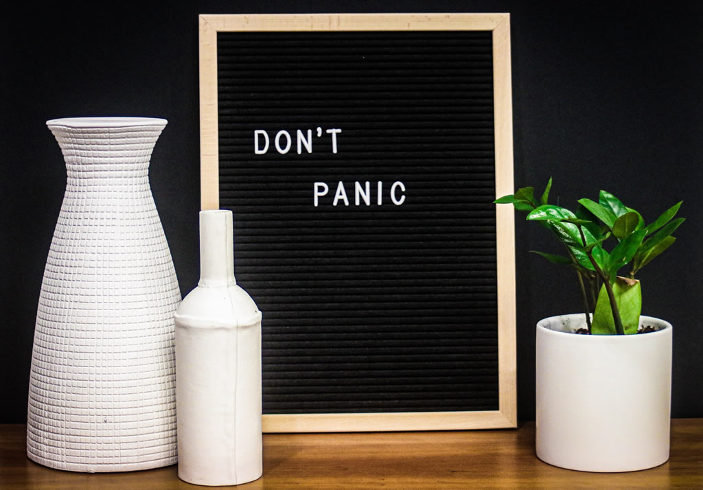 sign that says, "Don't panic"